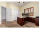 Home office featuring carpet flooring, a window with shutters, and a built-in desk at 4255 S Marisol Ln, Gilbert, AZ 85297