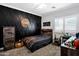 Stylish bedroom featuring a unique black accent wall and basketball-themed decor at 4606 S Marron --, Mesa, AZ 85212