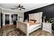 Bedroom featuring white wood frame bed, black accent wall and wood-look floors at 4606 S Marron --, Mesa, AZ 85212