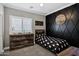 Modern bedroom with geometric accent wall, baseball decor and natural light at 4606 S Marron --, Mesa, AZ 85212