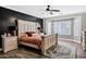 Bedroom featuring white wood frame bed, black accent wall and plenty of natural light at 4606 S Marron --, Mesa, AZ 85212