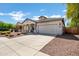 Inviting home with a covered porch, two car garage, desert landscaping, and a well-maintained exterior at 4606 S Marron --, Mesa, AZ 85212