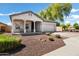 Charming single-story home boasts a covered porch, desert landscaping, and an attached two-car garage at 4606 S Marron --, Mesa, AZ 85212