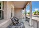 Inviting front porch with stylish seating, patterned rug, stucco walls, and views of the street at 4606 S Marron --, Mesa, AZ 85212