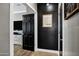Hallway featuring lovely tiled flooring, contrasting dark walls, and decorative wall art at 4606 S Marron --, Mesa, AZ 85212
