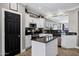Well-lit kitchen boasts stainless steel appliances, granite counters, white cabinetry and a convenient center island at 4606 S Marron --, Mesa, AZ 85212