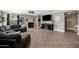 Large living room featuring tile floors, cozy seating, modern decor, and a decorative fireplace at 4606 S Marron --, Mesa, AZ 85212