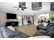 Spacious living room featuring tile floors, ceiling fan, stylish lighting, and open floorplan at 4606 S Marron --, Mesa, AZ 85212