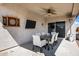Covered patio with a dining table, ceiling fan, outdoor lighting, dart board, and heater at 4606 S Marron --, Mesa, AZ 85212
