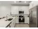 Bright kitchen features stainless steel appliances, white cabinetry and countertops, and tile flooring at 4657 S Vapor --, Mesa, AZ 85212