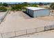 Metal storage building with a large covered area, gravel parking, and fenced enclosure at 51089 W Julie Ln, Maricopa, AZ 85139