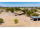 View of the front of this property with a long overhang and gravel drive; red car parked in front at 51089 W Julie Ln, Maricopa, AZ 85139