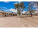 Expansive backyard featuring a covered patio, fire pit, and desert landscaping at 51089 W Julie Ln, Maricopa, AZ 85139