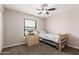 Cozy bedroom featuring a twin bed, ceiling fan, carpet and closet for storage at 51089 W Julie Ln, Maricopa, AZ 85139