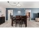 Cozy dining area with modern lighting, seating for six, and access to other rooms at 51089 W Julie Ln, Maricopa, AZ 85139