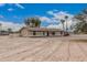 Well maintained single-story home showcasing neutral stucco, front porch, and desert landscaping at 51089 W Julie Ln, Maricopa, AZ 85139