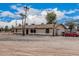 Inviting home showcasing a covered porch, mature palm trees, and a spacious front yard at 51089 W Julie Ln, Maricopa, AZ 85139