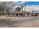 Charming single story home featuring a covered porch, desert landscaping, and neutral paint scheme at 51089 W Julie Ln, Maricopa, AZ 85139