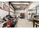 Spacious garage with exposed steel beam framing and multiple classic cars at 51089 W Julie Ln, Maricopa, AZ 85139