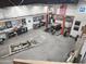 Spacious garage featuring an auto lift, tools, and vintage car posters at 51089 W Julie Ln, Maricopa, AZ 85139