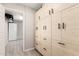 Bright hallway with floor to ceiling storage and a glimpse into another room at 51089 W Julie Ln, Maricopa, AZ 85139