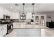Well-designed kitchen featuring granite countertops, stainless steel appliances, and a center island with bar seating at 51089 W Julie Ln, Maricopa, AZ 85139