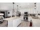 A spacious kitchen with granite countertops, stainless steel appliances, a large island and an adjacent dining area at 51089 W Julie Ln, Maricopa, AZ 85139