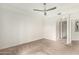 Large bedroom with a ceiling fan, soft carpet, and access to multiple rooms, providing a versatile layout at 5450 E Deer Valley Dr # 3023, Phoenix, AZ 85054