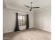 Spacious bedroom with a ceiling fan, plush carpeting, and a window with curtains for ample natural light at 5450 E Deer Valley Dr # 3023, Phoenix, AZ 85054