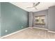 Comfortable bedroom with neutral paint, a ceiling fan, and a large window to let in natural light at 5450 E Deer Valley Dr # 3023, Phoenix, AZ 85054