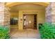 Complex entrance with stone accents and a wooden door at 5450 E Deer Valley Dr # 3023, Phoenix, AZ 85054