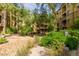 Landscaped exterior view of complex with shaded seating area and manicured bushes at 5450 E Deer Valley Dr # 3023, Phoenix, AZ 85054