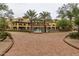 Community exterior featuring mature palm trees, brick drive, and a pool at 5450 E Deer Valley Dr # 3023, Phoenix, AZ 85054