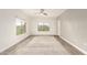Spacious living room with a ceiling fan, large windows, and vinyl plank flooring at 5450 E Deer Valley Dr # 3023, Phoenix, AZ 85054
