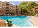 Resort-style pool area with waterfall feature, surrounded by lush landscaping and comfortable lounge chairs at 5450 E Deer Valley Dr # 3023, Phoenix, AZ 85054