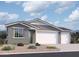 Charming single-story home featuring a two-car garage, neutral stucco siding, and meticulously landscaped front yard at 5510 W Buist Ave, Laveen, AZ 85339