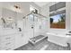 Elegant bathroom featuring patterned tile floors, a freestanding tub, and a glass-enclosed shower at 6041 E Hartford Ave, Scottsdale, AZ 85254