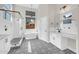 Modern bathroom with a stand-alone tub, walk-in shower, patterned tile floors, and modern fixtures at 6041 E Hartford Ave, Scottsdale, AZ 85254