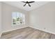 This bright bedroom features wood-look flooring and plantation shutters at 6041 E Hartford Ave, Scottsdale, AZ 85254