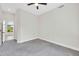 A bright bedroom features neutral walls, carpet and a ceiling fan at 6041 E Hartford Ave, Scottsdale, AZ 85254