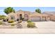 Charming single-story home featuring a three-car garage, landscaped front yard, and desert-friendly plantings at 6041 E Hartford Ave, Scottsdale, AZ 85254
