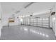 A large garage with painted floors and built-in storage at 6041 E Hartford Ave, Scottsdale, AZ 85254