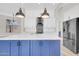 Stylish kitchen island with modern fixtures, stainless steel appliances, and contemporary pendant lighting at 6041 E Hartford Ave, Scottsdale, AZ 85254