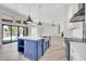 Bright kitchen featuring a center island, stainless steel appliances, and easy access to a spacious outdoor living area at 6041 E Hartford Ave, Scottsdale, AZ 85254