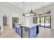 Gourmet kitchen with a large island, stainless steel appliances, and easy access to an outdoor area at 6041 E Hartford Ave, Scottsdale, AZ 85254