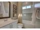 Bright bathroom featuring a shower-tub combo, white cabinets, and framed artwork for a stylish touch at 6091 N Sunrise Ln, Buckeye, AZ 85396