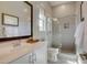 Bathroom with sleek vanity, modern mirror, glass-enclosed shower, and contemporary fixtures at 6091 N Sunrise Ln, Buckeye, AZ 85396