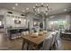 Open-concept dining area with a view of the kitchen and living space, featuring modern lighting at 6091 N Sunrise Ln, Buckeye, AZ 85396