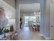Bright open-concept foyer with wood flooring, and an elegant view of the dining and living areas at 6091 N Sunrise Ln, Buckeye, AZ 85396