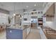 Stylish kitchen with a large island, stainless steel appliances, gas cooktop and bright, open layout at 6091 N Sunrise Ln, Buckeye, AZ 85396